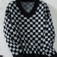 Cozy black knit with a bold checkerboard pattern for everyday wear.
