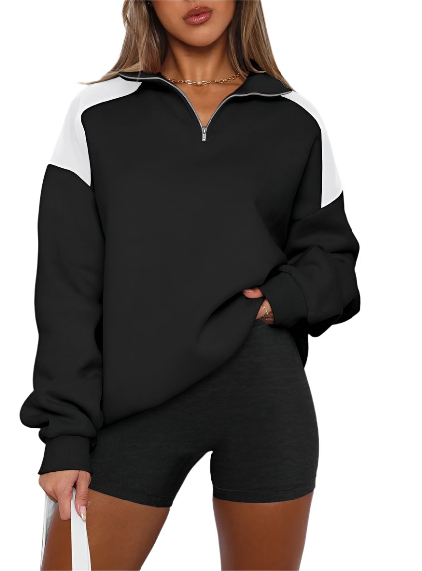 Women's black color block half-zip sweatshirt, styled casually.
