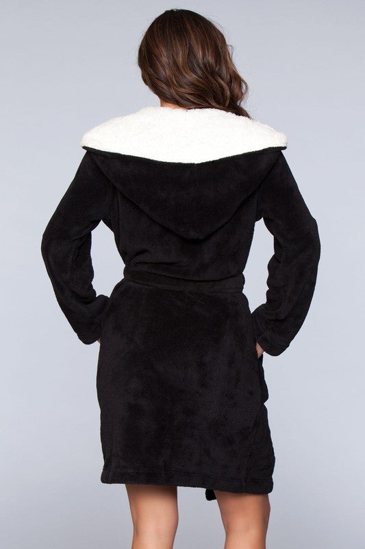 Black color-block robe with side pockets and a faux fur-lined hood, perfect for lounging.
