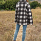 Chic boucle plaid coat for women, featuring side pockets and a lapel neck.
