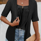 Black faux layered eyelet top styled with distressed jeans for a relaxed vibe