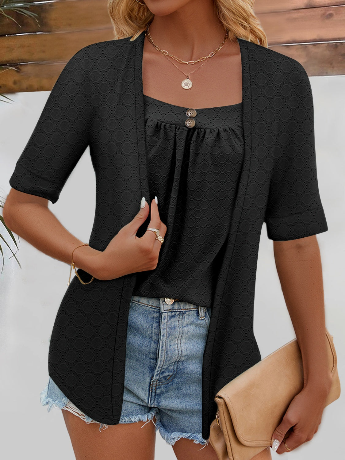 Black faux layered eyelet top styled with distressed jeans for a relaxed vibe