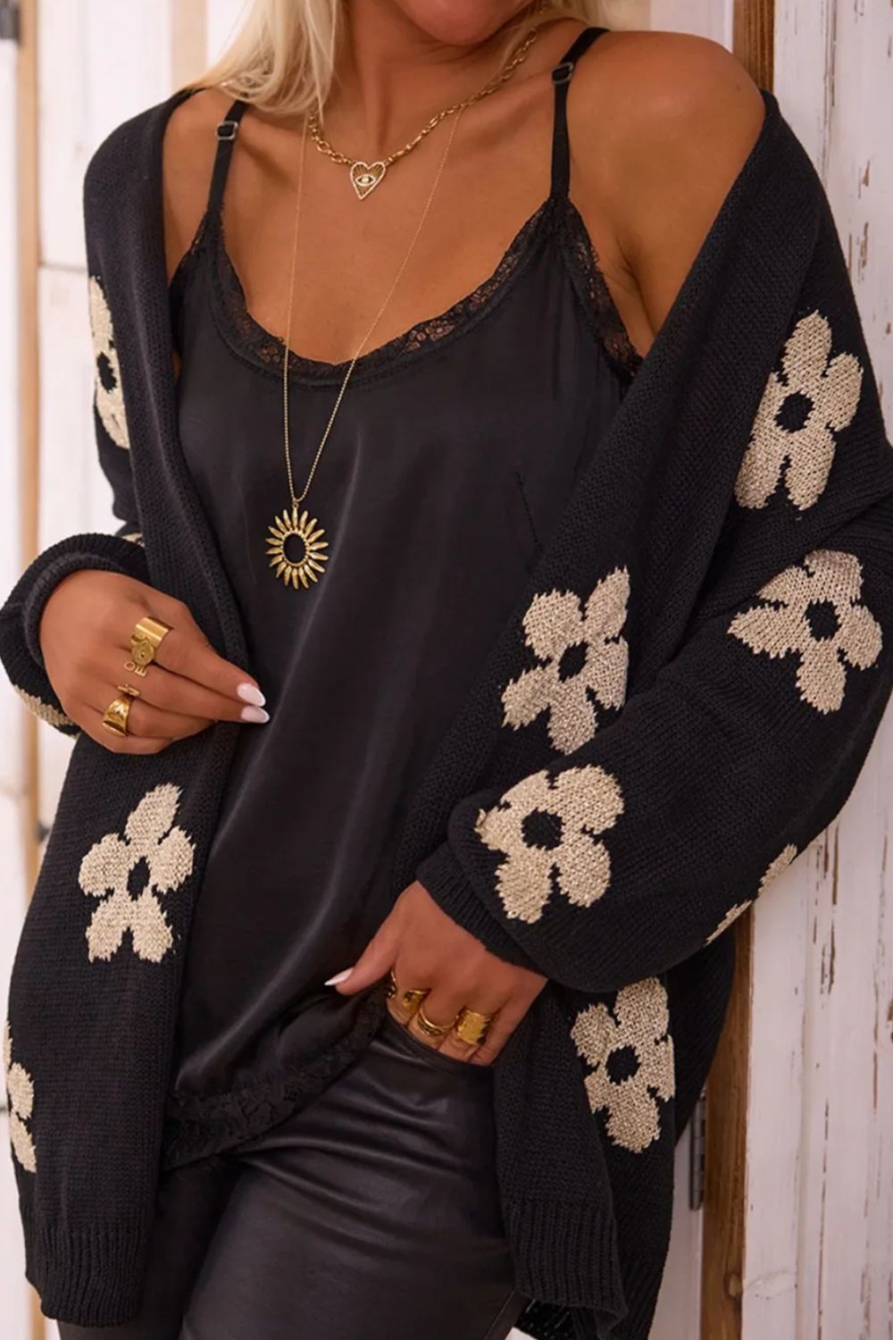 Front view of black floral cardigan with white flowers