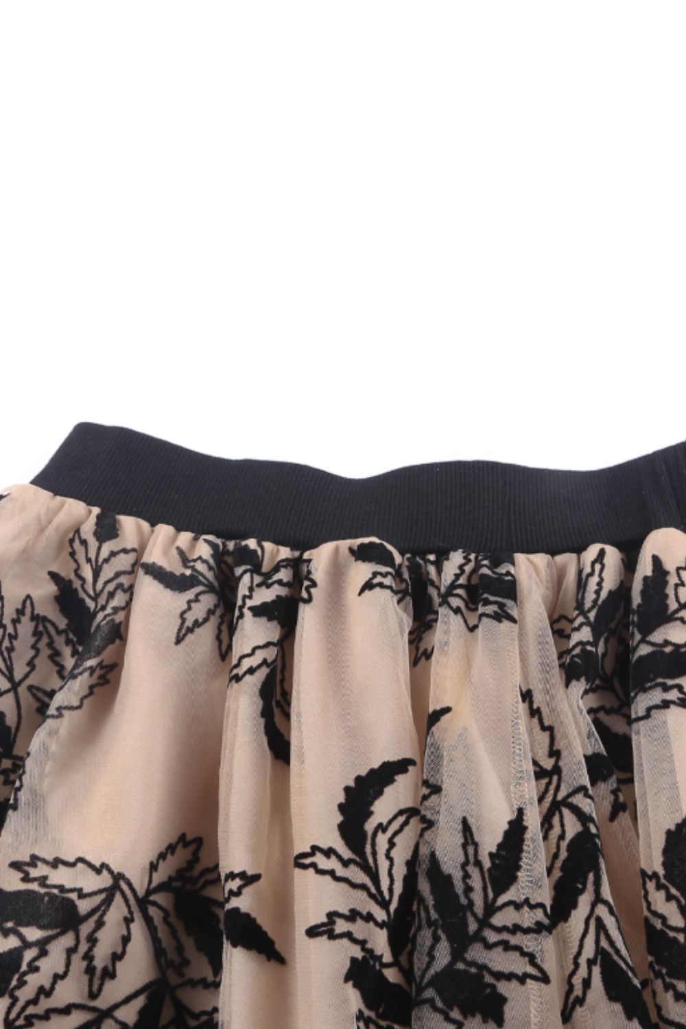 Flowing mesh midi skirt in khaki with elegant black embroidery.
