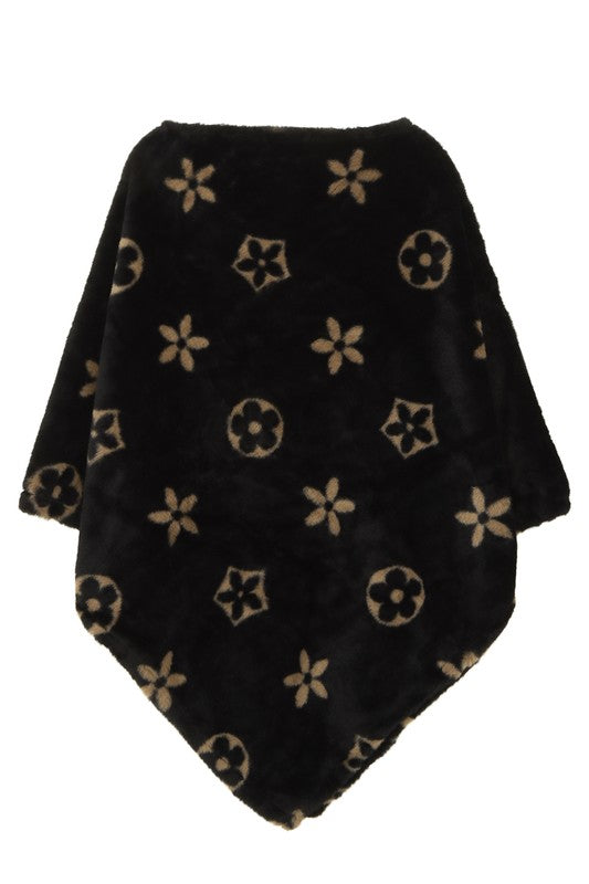 Black poncho with elegant floral design, fuzzy texture
