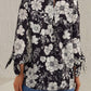 Women’s classic black and white floral blouse with tied sleeves for a feminine touch.
