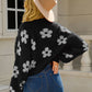 Soft and cozy black knit cardigan with floral pattern
