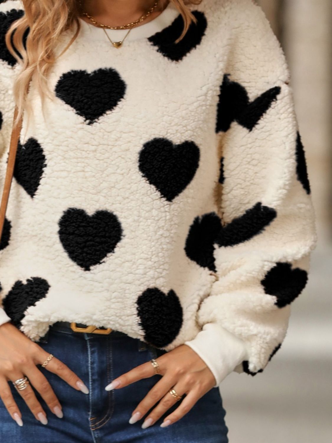 Black fuzzy heart sweatshirt styled for a casual day out