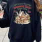 Classic black holiday sweatshirt with a festive gingerbread bakery graphic.