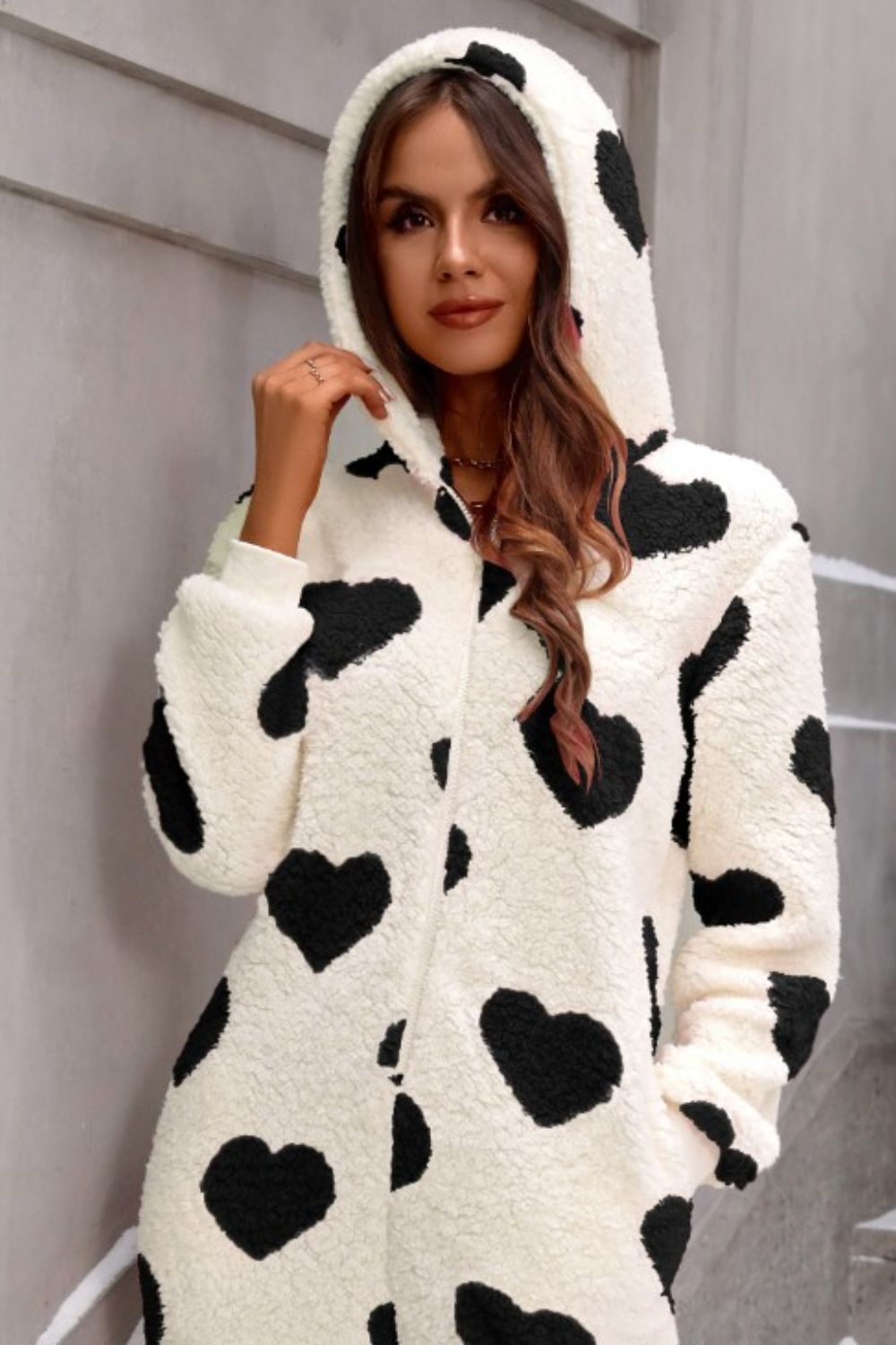 Black heart-print hooded jumpsuit in soft sherpa fabric
