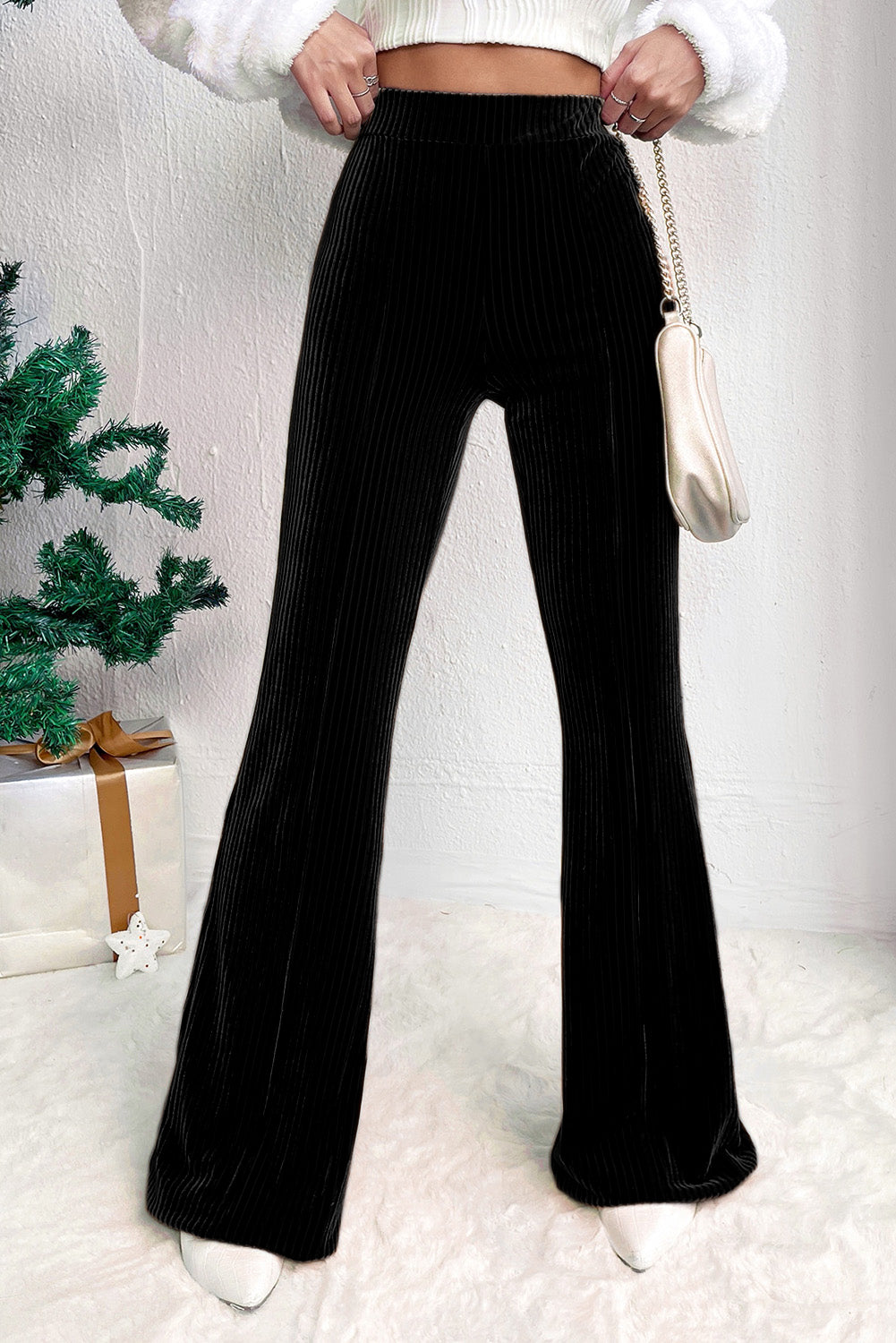 High-waist corduroy flare pants in black for a sleek, retro look.
