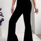 Soft corduroy black flare pants paired with heeled boots.
