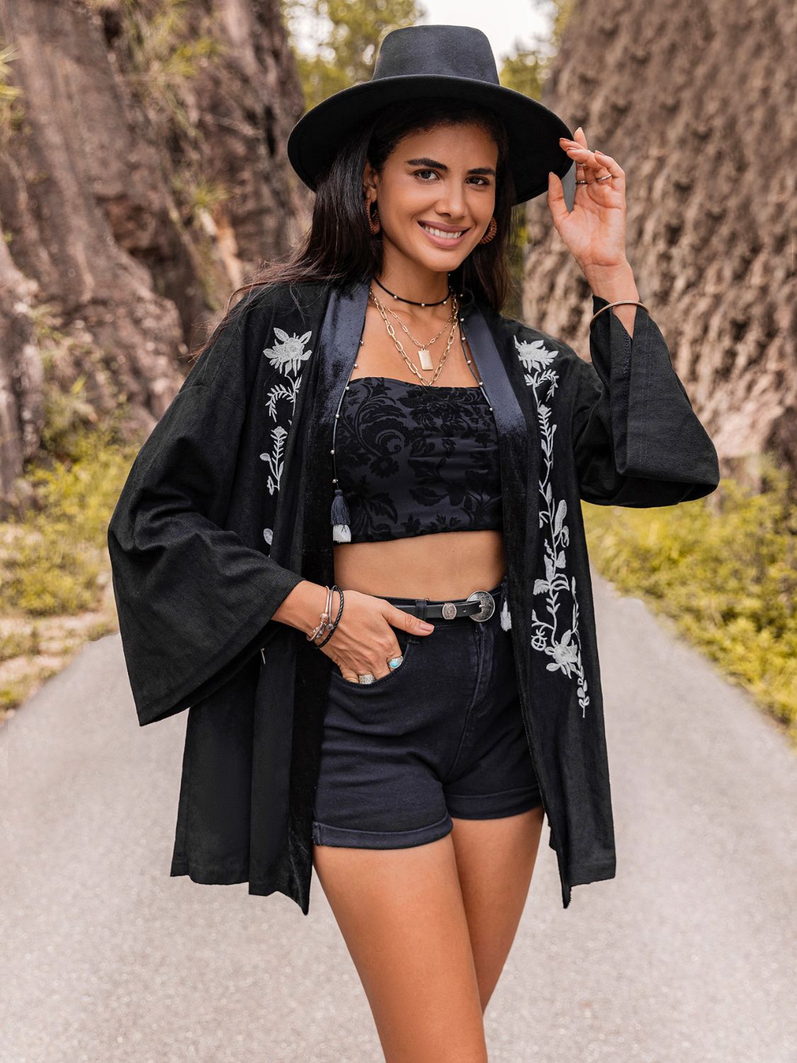 Women’s black kimono cardigan with intricate bohemian embroidery.
