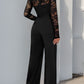 Full-length view of black lace jumpsuit, ideal for evening wear.
