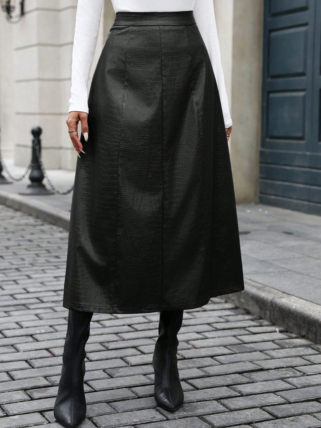 Black midi skirt with crocodile texture and faux leather design.