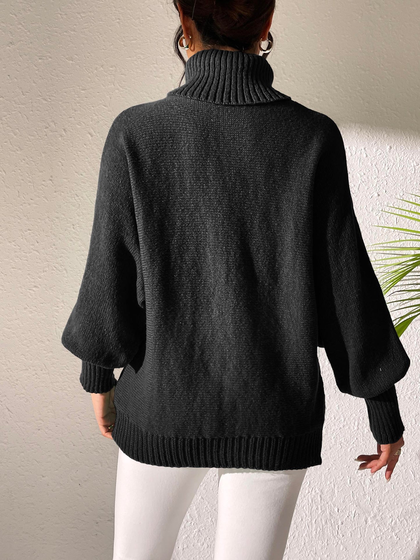 Black oversized turtleneck sweater styled with jeans for a cozy look