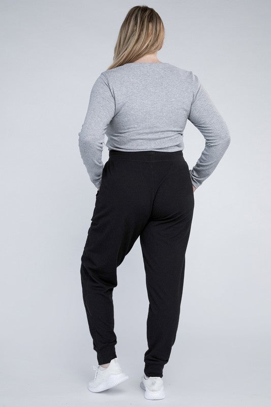 Plus-size ankle-length black jogger pants with a relaxed silhouette.
