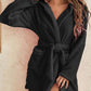 Black hooded robe in soft plush fabric, perfect for chilly evenings.
