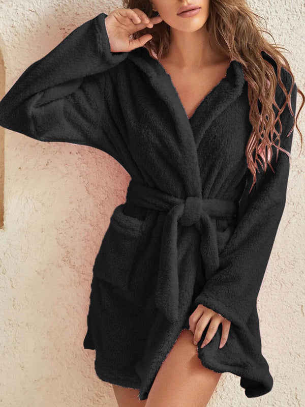 Black hooded robe in soft plush fabric, perfect for chilly evenings.
