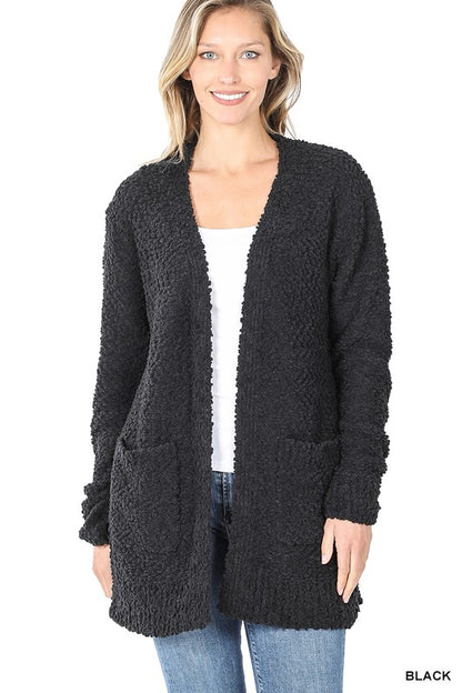 Woman wearing black popcorn cardigan