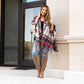 Comfortable and stylish plaid shawl with fringe trim.