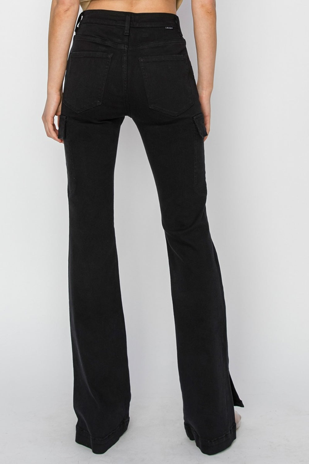 Back view of black RISEN High Rise Side Slit Cargo Bootcut Jeans highlighting back pockets.