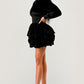 Mock neck black dress with cascading ruffles on the skirt for an elevated look.
