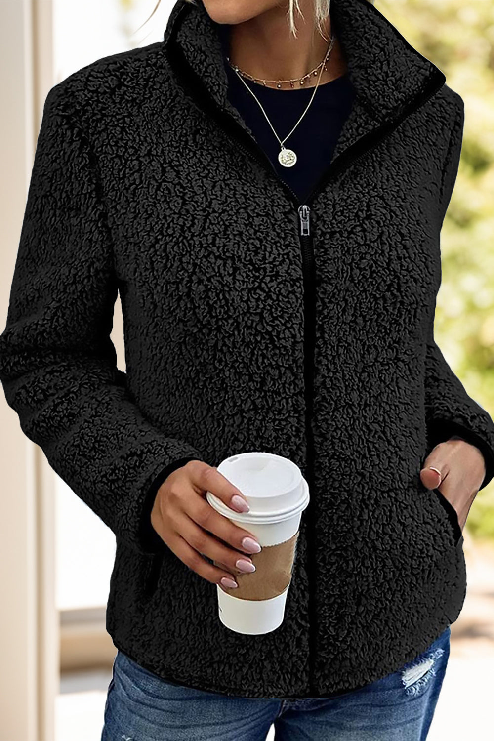 Black fleece sherpa jacket for women, ideal for winter layering and staying warm.
