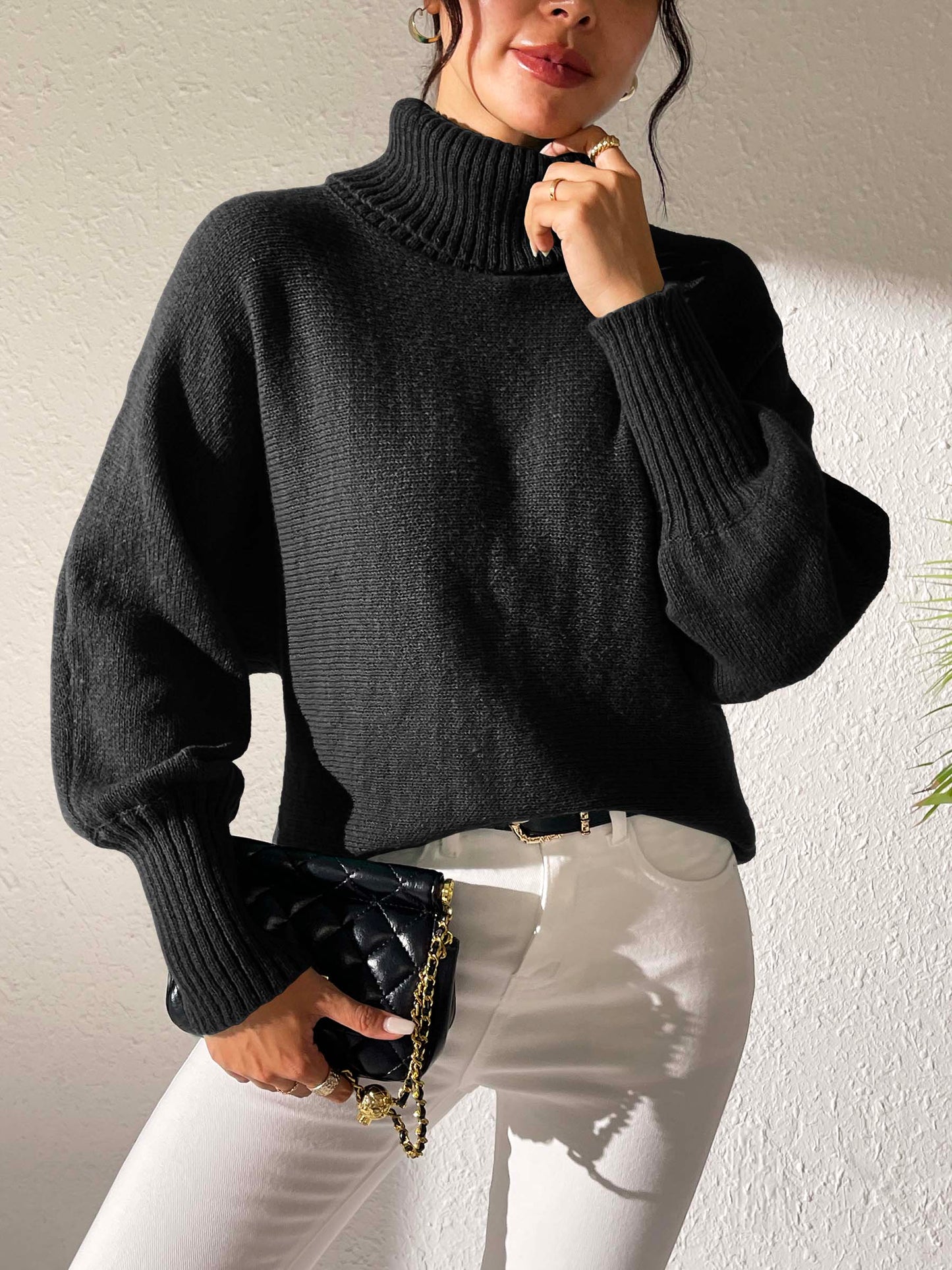 Black oversized turtleneck sweater styled for casual wear