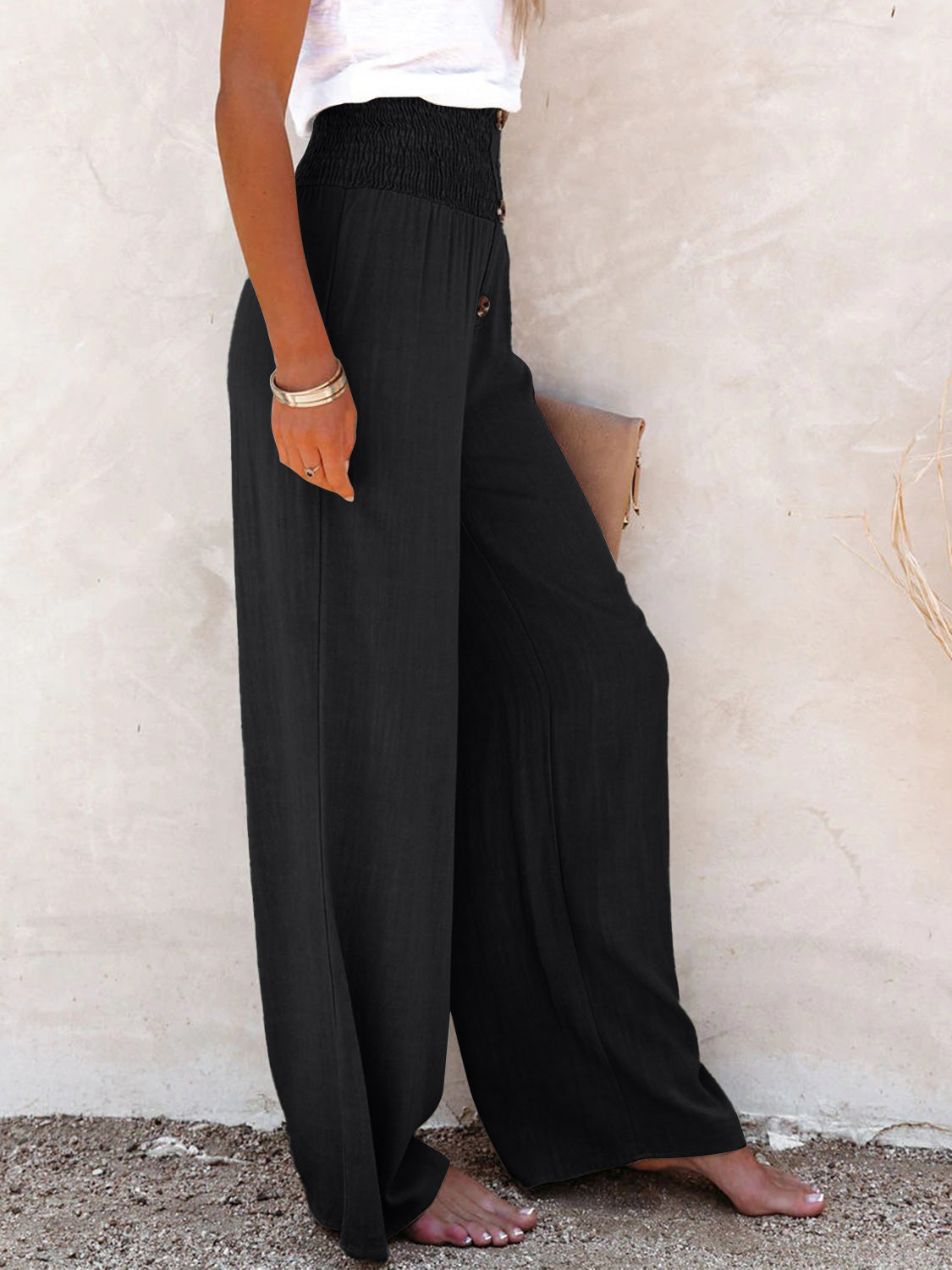 Black smocked waist wide-leg pants for women, ideal for casual or dressy occasions.