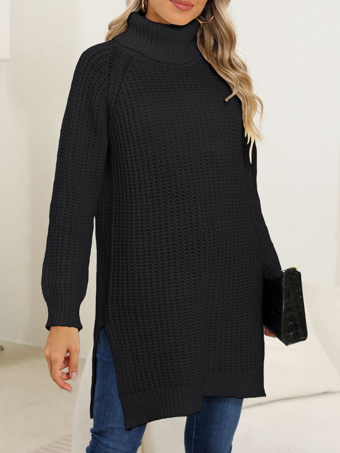 Black winter pullover with a turtleneck and slit details.
