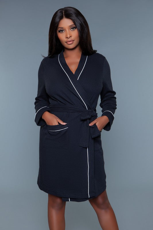 Front view of a black waffle robe with a belted waist and patch pockets, ideal for plus-size lounging.
