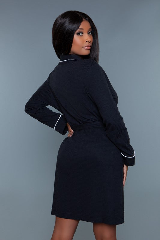 Back view of a black waffle robe showing the belted waist and relaxed fit.
