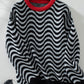 Full-length view of the black wavy stripe sweater, great for versatile, everyday wear.

