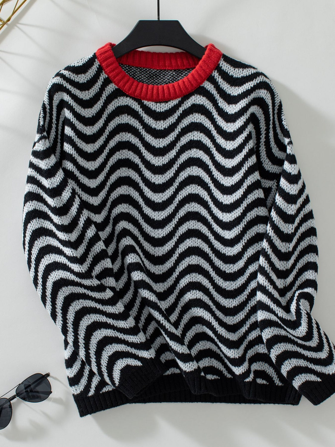 Full-length view of the black wavy stripe sweater, great for versatile, everyday wear.

