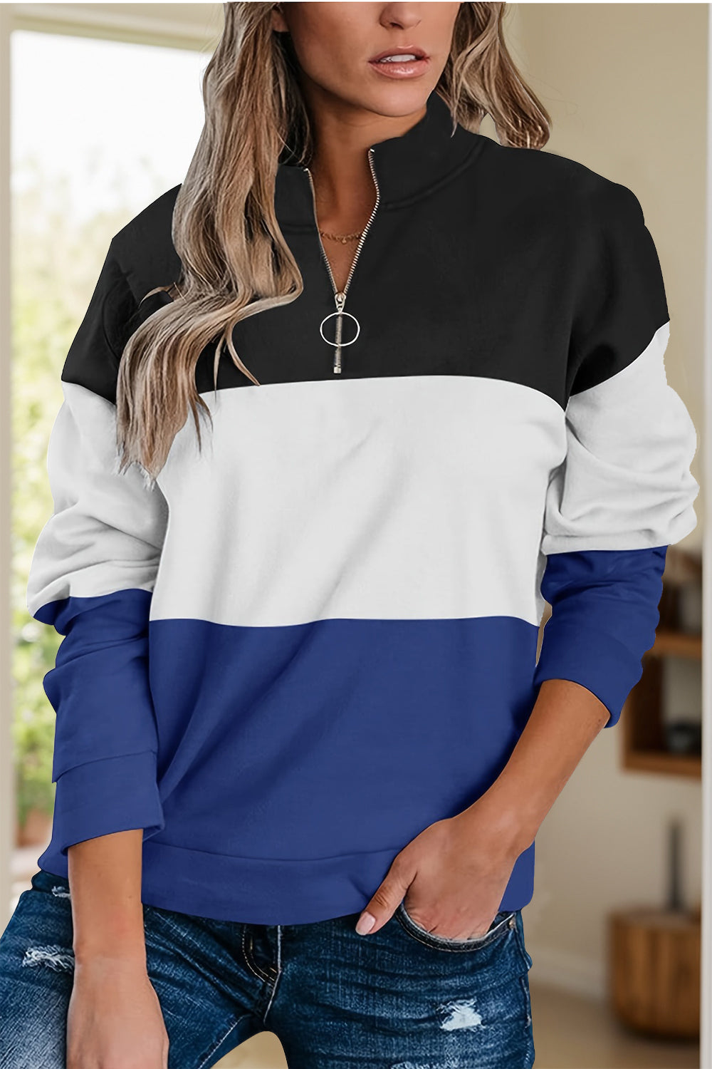 Black, white, and blue color block half-zip pullover for women.
