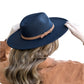 Black wide brim Panama hat with a tassel belt shown from the side profile.
