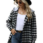 Woman wearing a black women's plaid jacket with hood and sunglasses
