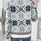 Back view of the blue and white Nordic snowflake sweater, showcasing its cozy design.