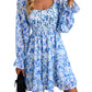 Blue bohemian floral dress with a square neckline, flowy long sleeves, and tiered hemline.
