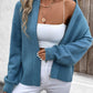 Cozy blue cardigan with ribbed knit texture, perfect for casual layering.
