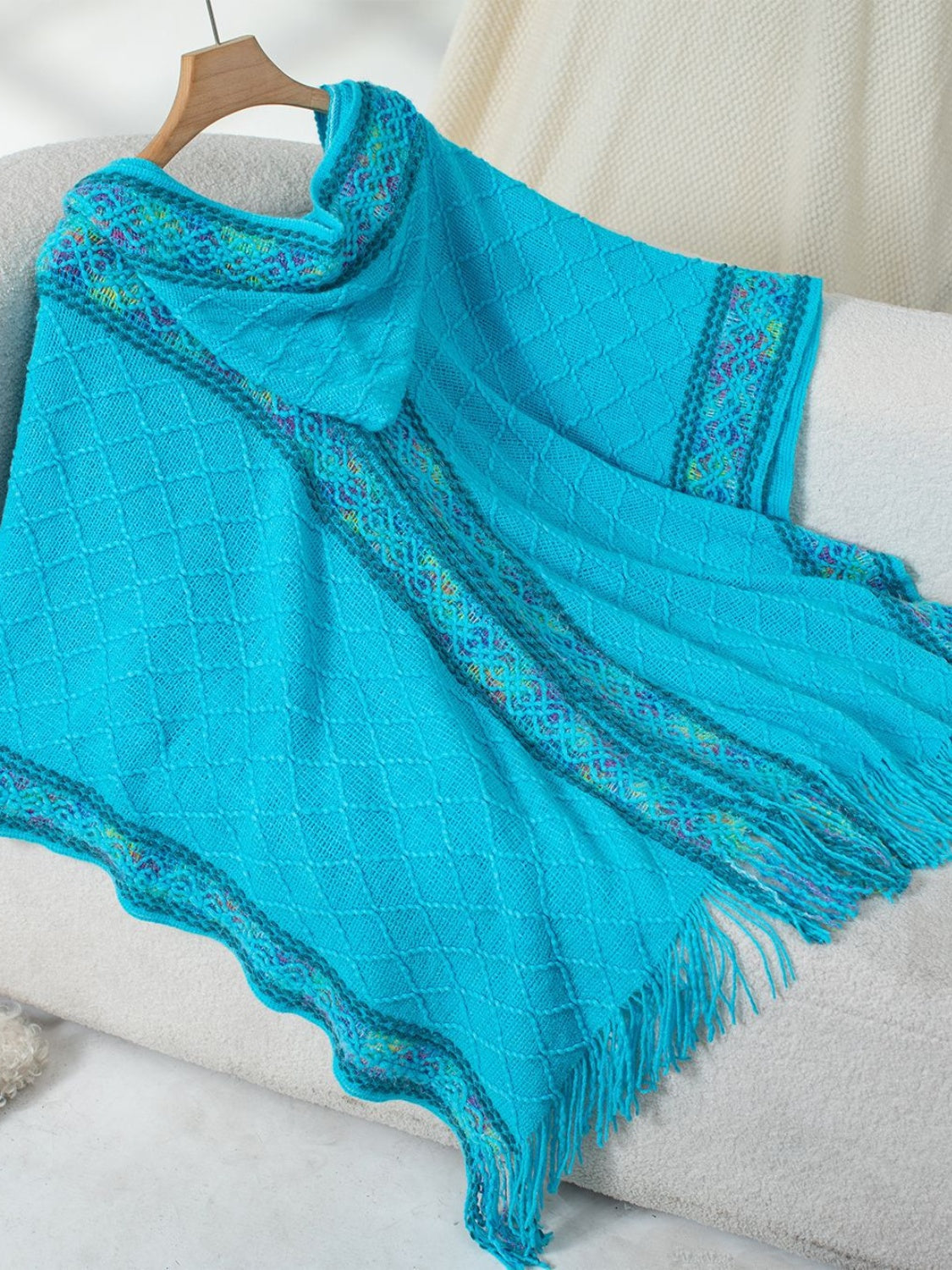 Casual blue poncho with hood and multicolor accents
