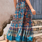 Side profile of a lightweight blue patchwork maxi skirt in an A-line silhouette.
