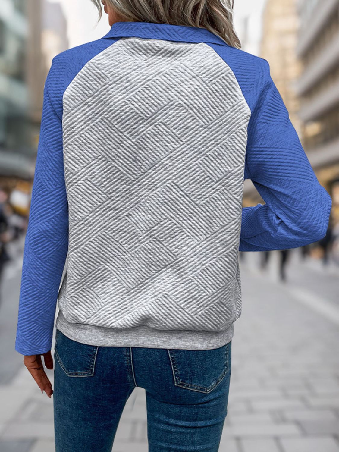 Blue quilted pullover with a geometric pattern and sporty raglan sleeves