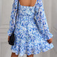 Blue floral-print dress with a bohemian vibe, complete with long sleeves and ruffle details.
