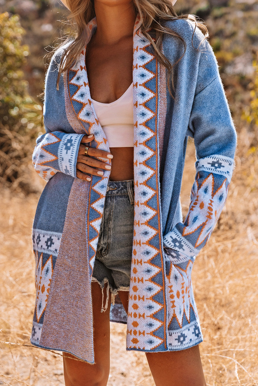 Blue tribal knit cardigan featuring bold geometric patterns
