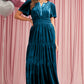 Luxurious blue velvet maxi dress with pockets and flattering waist detail
