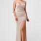 Front view of a blush mermaid gown with spaghetti straps and a side slit.
