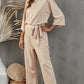 Boat neck apricot jumpsuit with a flattering high waist and elegant design.
