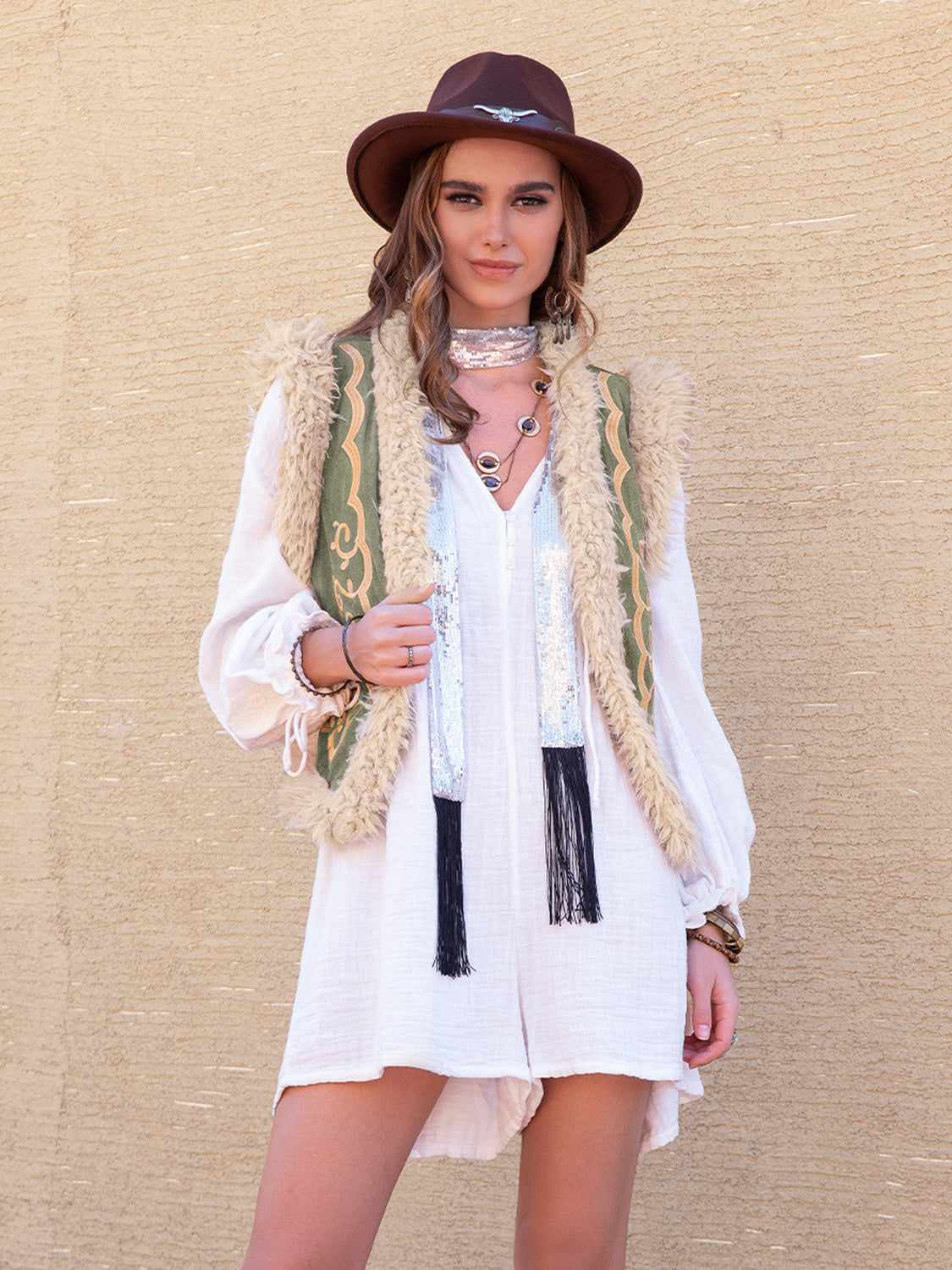 Vintage-inspired Western vest with embroidered detailing and shearling trim.
